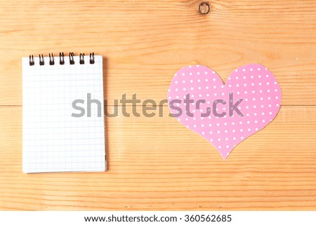 blank card and handmade heart over wooden background
