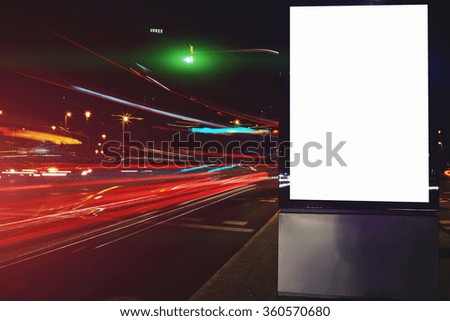 Electronic billboard with blank copy space screen background for your text message or content, public information board outside at night, advertising mock up banner with blurred lights on background