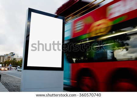 Blank billboard with copy space for your text message or promotional content, public information board in city with with blurred bus on background, empty advertising mock up banner on roadway