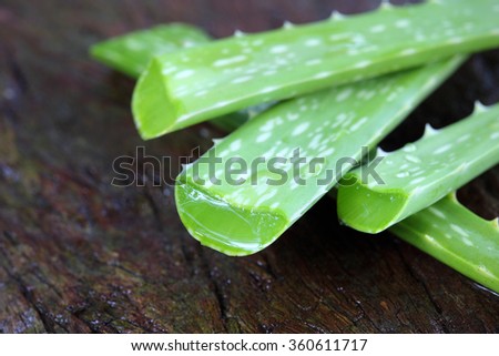 Aloe Vera leaves on wooden background