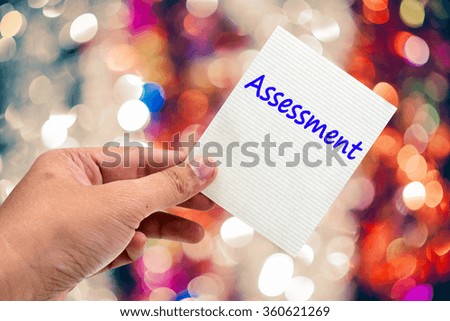 Open notebook with pen,Assessment word.