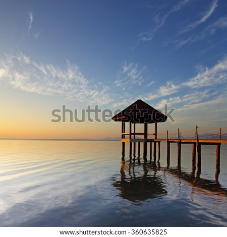 Beautiful morning light of wooden landing with pavilion in the sea at Black Sand Beach, Trat Province of Thailand