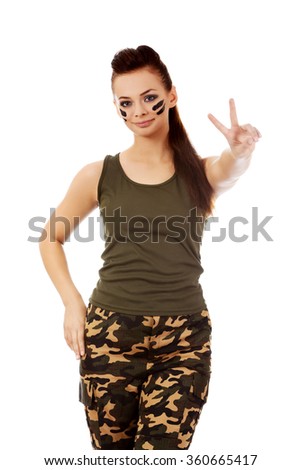 Military woman gesturing peace with fingers