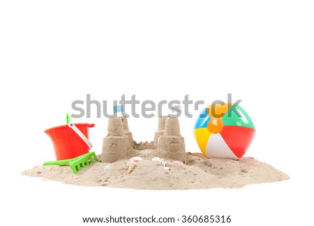 Beach with sandcastle and toys isolated over white background