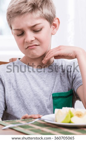 Picture of disgusred boy dislike healthy food