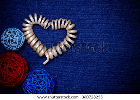 Wooden composition and space for text. Romantic love theme on jeans background. Toned.