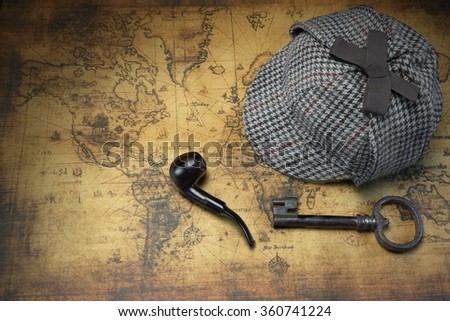 Deerstalker Sherlock Holmes Hat, Vintage Key And Smoking Pipe On The Old World Map Background. Overhead View.  Investigation Concept.
