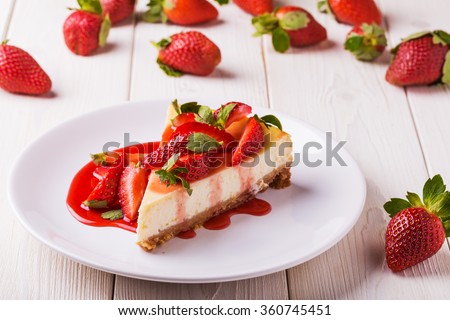 Delicious homemade cheesecake with strawberries  on  white wooden table. Royalty-Free Stock Photo #360745451