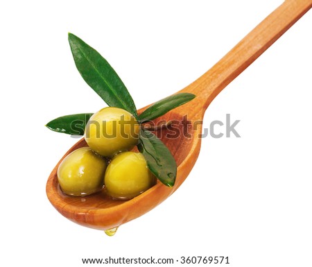 Green olives on a wooden spoon. Isolated on white background