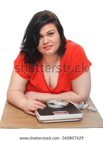 Overweight woman with measure tape and weighing machine. Picture on slimming theme.