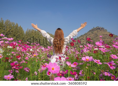 beautiful woman with the cosmos flower field
