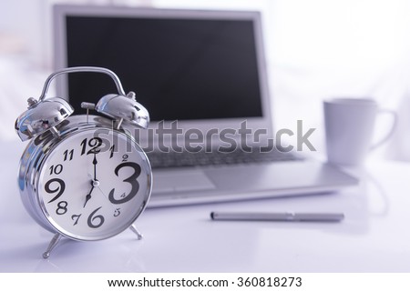 Alarm clock on office desk selecttive focus