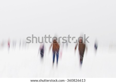 Abstract winter background with silhouettes hurried  in snowfall