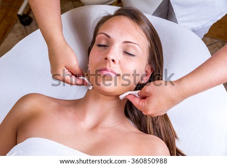 Freckles woman having a cosmetic treatment at the beauty salon. Royalty-Free Stock Photo #360850988