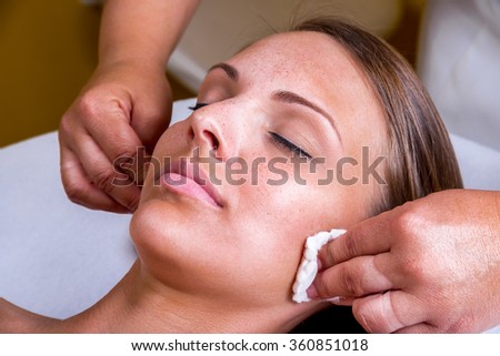 Freckles woman having a cosmetic treatment at the beauty salon. Royalty-Free Stock Photo #360851018
