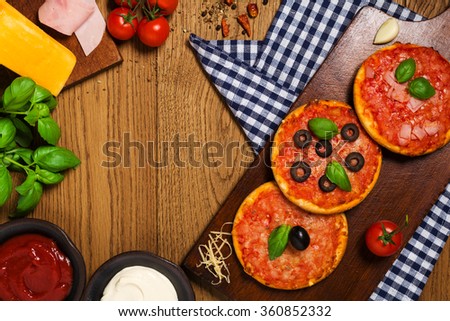 Mix of mini pizzas on wooden board