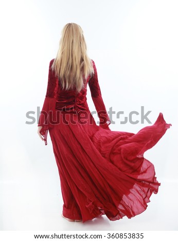 beautiful lady with long blonde hair wearing a red medieval fantasy gown. standing, isolated on white background. Royalty-Free Stock Photo #360853835