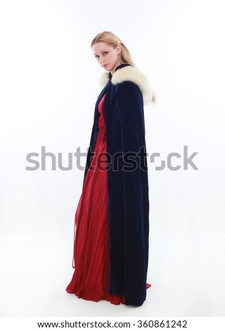 beautiful lady with long blonde hair wearing a red medieval fantasy gown and a blue fur cloak. standing, isolated on white background.