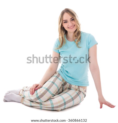 young beautiful woman in pajamas sitting isolated on white background