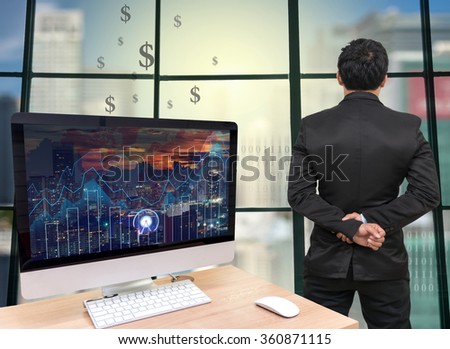 the computer on the wood table with trading graph at the screen in front of the glass window over on the trading graph over the blurred photo of cityscape,Back side of Businessman