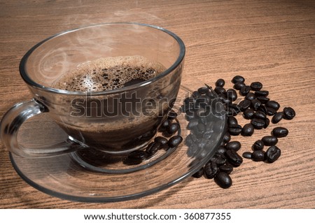 Hot Coffee and cup of coffee on wood texture background