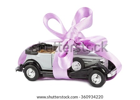 Car with bow as gift isolated on white background