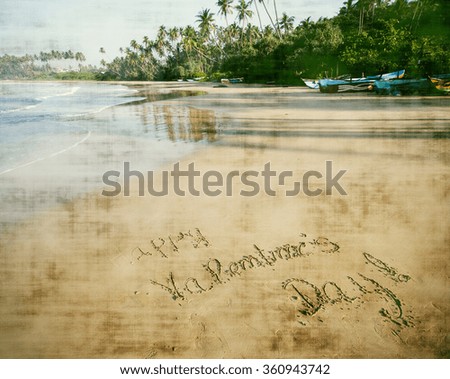 "Happy Valentines day!" written in sand on tropical beach - vintage photo