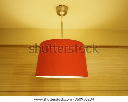 Modern red hanging lamp on wood background