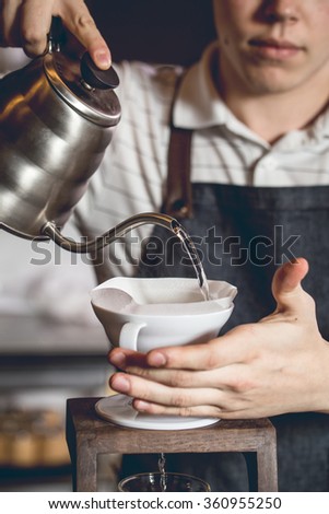 Barista making coffee in coffeeshop