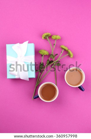 Gift box with flowers on pink background