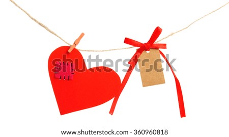 Paper hearts and empty sheet hang on cord isolated on white background