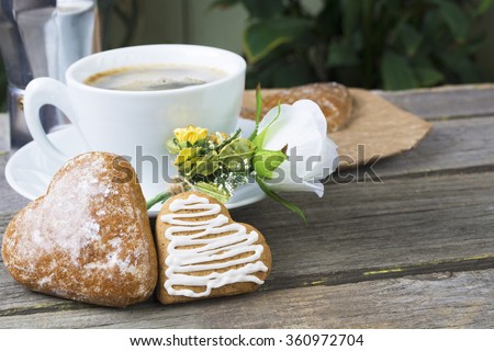 Heart shaped  cookies (big and small as couple), cup of coffee, bouquet of flowers decoration. sunny morning.Steam (geyser) coffee maker. Romantic breakfast or  Valentine's Day Breakfast. Toned image
