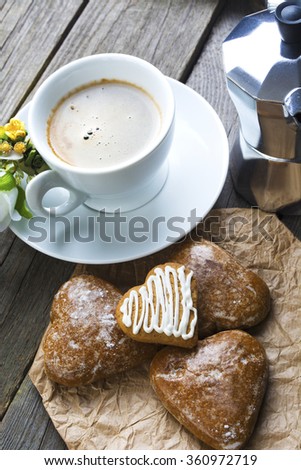Heart shaped cookies, cup of coffee, bouquet of flowers decoration on old wooden table. sunny morning.Steam (geyser) coffee maker. Romantic breakfast or  Valentine's Day Breakfast. Toned image