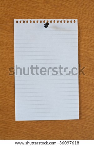 blank white page from notebook on wooden wall