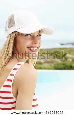 Young woman in swimsuit, smiling at camera