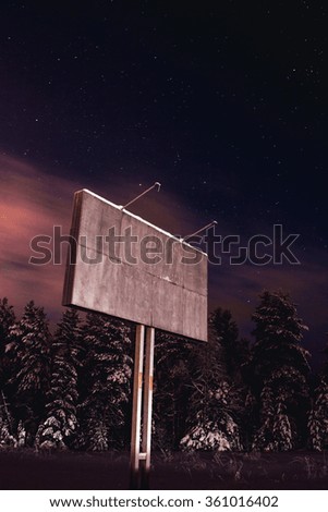 Blank billboard near expressway at winter night 