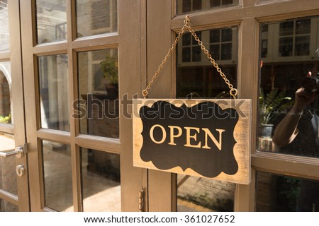 Wooden board sign that says Open from a restaurant