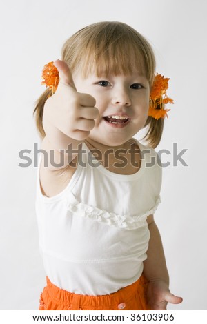 Little girl making the OK sign. Isolated on white.