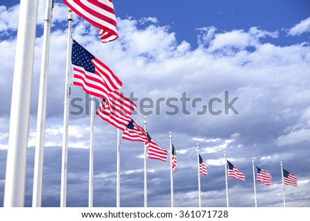 American flags winding on the blue sky
