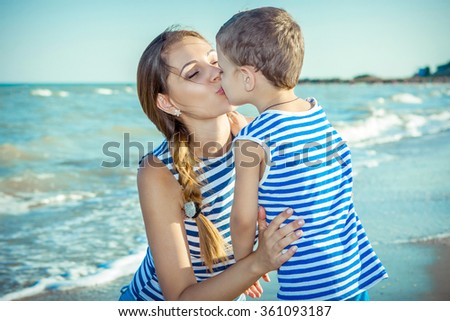 Happy family. Young happy beautiful  mother and her son having fun on the beach. Positive human emotions, feelings.
