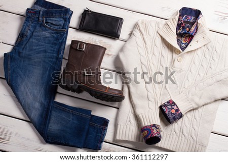 Set of men's clothing on a wooden background. Fashionable winter men's clothing. 