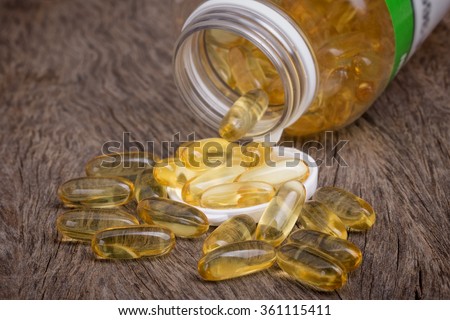 The container with pills of omega 3. Fish oil for cholesterol.