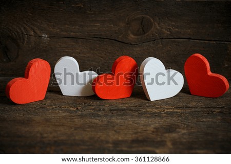 Red and white hearts on old shabby wooden background. Image of Valentines day
