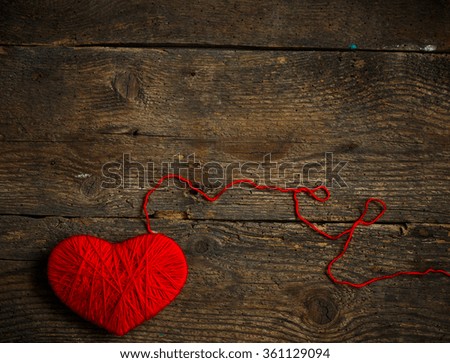 Red heart shape made from wool on old shabby wooden background. Image of Valentines day