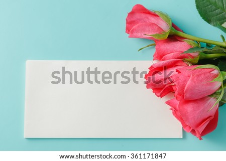 red rose and blank gift card for text on paper background