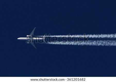 Boeing 777 civil airliner flying on high altitude. Royalty-Free Stock Photo #361201682