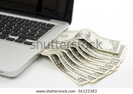 one dollar bills coming out from a laptop side slot