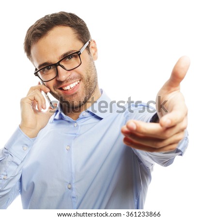 Successful gesturing business man with mobile 