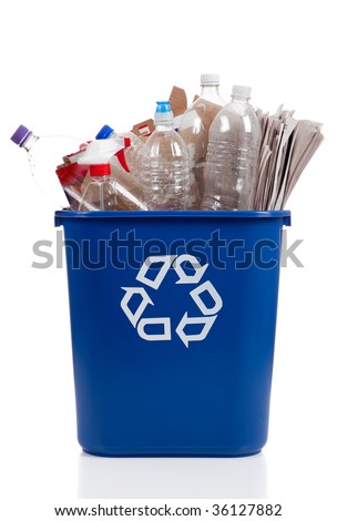 An overflowing blue recycle bin full of  plastic bottles, newspapers and boxes, with the recyle symbol on front