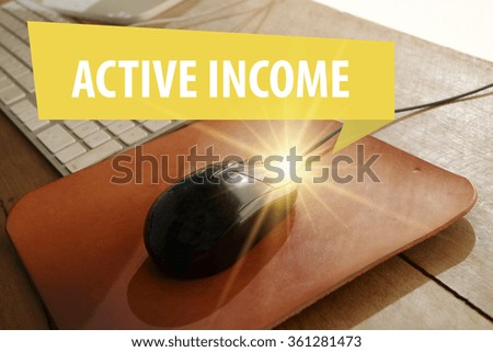ACTIVE INCOME concept with workstation on black mouse computer, business concept , business idea